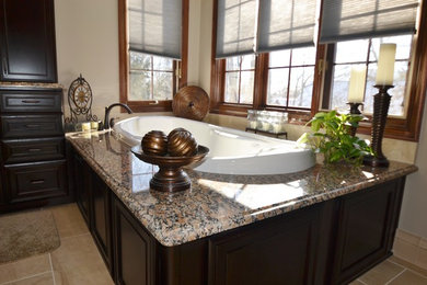 Inspiration for a large transitional master black tile and porcelain tile porcelain tile bathroom remodel in Columbus with an undermount sink, recessed-panel cabinets, dark wood cabinets, granite countertops, a one-piece toilet and beige walls