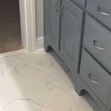 New tile floor. Used old vanity, raised and painted. Added decorative toe kicks.