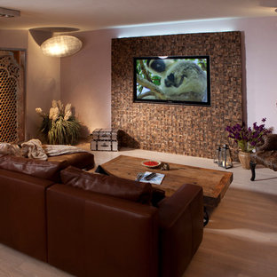 Inspiration for a large mediterranean open concept light wood floor home theater remodel in Cologne with multicolored walls and a media wall