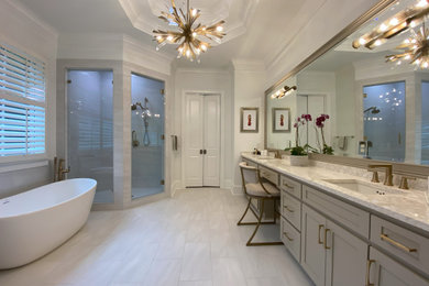 Large trendy master gray tile and porcelain tile double-sink bathroom photo in Atlanta with shaker cabinets, beige cabinets, a two-piece toilet, white walls, an undermount sink, quartz countertops, a hinged shower door, multicolored countertops and a built-in vanity