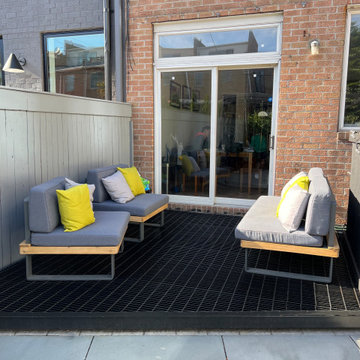 Paved patio with metal grating garden