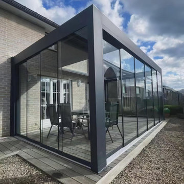 Louvered Motorized Pergola With Sliding Glass Door