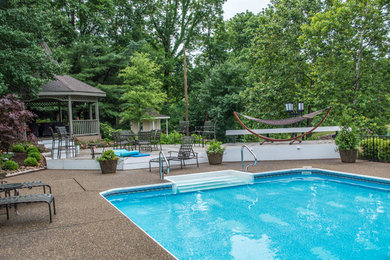 Example of a backyard patio design in Louisville with a gazebo