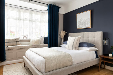 This is an example of a medium sized traditional master bedroom in London.