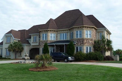 Huge beige two-story mixed siding exterior home idea in Charlotte with a hip roof