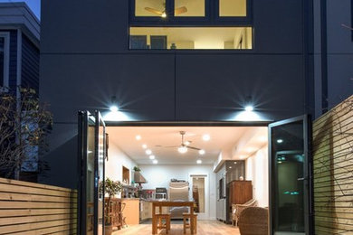 Mid-sized trendy gray two-story stucco house exterior photo in Toronto with a hip roof
