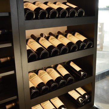 Stained Alderwood Wine Rack Complements a Glass Wine Room