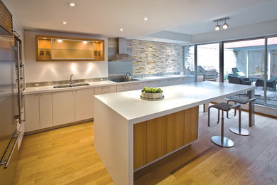 Modern kitchen in Toronto with stainless steel appliances and with island.