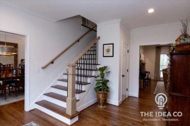 Example of a mid-sized transitional light wood floor and brown floor foyer design in Other with white walls
