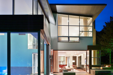 Huge contemporary gray two-story stucco exterior home idea in Toronto with a shed roof