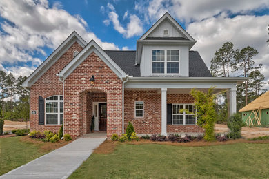 Example of a mid-sized classic red two-story brick gable roof design in San Diego