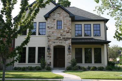 Example of a mid-sized classic beige two-story mixed siding exterior home design in Houston