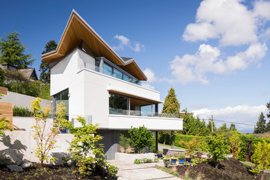 Design ideas for a modern three-storey exterior in Vancouver.