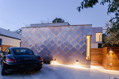 Mid-sized minimalist yellow two-story metal flat roof photo in Austin