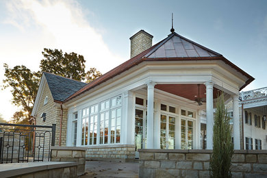 Inspiration for a mid-sized timeless white one-story stone house exterior remodel in Vancouver with a mixed material roof