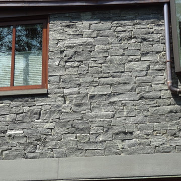 Traditional Newton Home with Greenwich Gray Stacked Stone Cladding