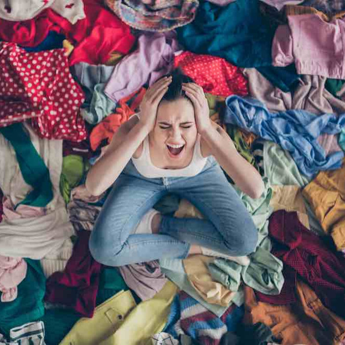 woman stressed over messy closet
