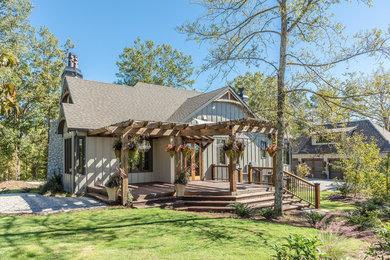 Example of a mountain style green wood exterior home design in Atlanta with a shingle roof