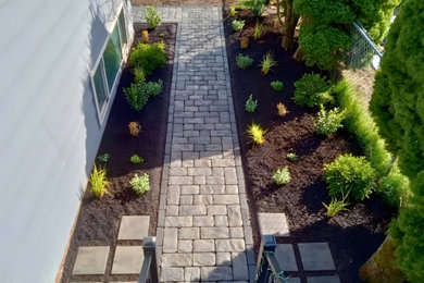 Inspiration for a contemporary side yard concrete paver walkway.