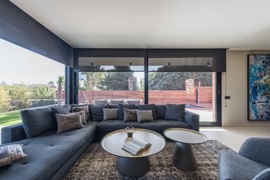 Example of a mid-sized trendy ceramic tile and beige floor family room design in Other with beige walls