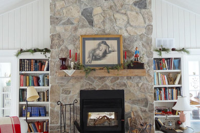 Living room library - large traditional open concept medium tone wood floor living room library idea in Toronto with white walls, a two-sided fireplace and a stone fireplace