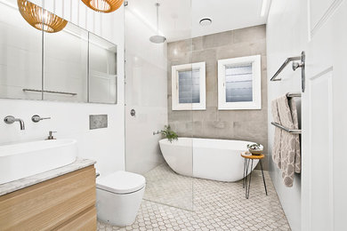 Inspiration for a contemporary master bathroom in Sydney with flat-panel cabinets, medium wood cabinets, a freestanding tub, an open shower, a one-piece toilet, beige tile, white walls, a console sink and an open shower.