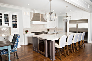 Photo of an expansive traditional l-shaped eat-in kitchen in Detroit with an undermount sink, beaded inset cabinets, white cabinets, quartz benchtops, multi-coloured splashback, ceramic splashback, stainless steel appliances, dark hardwood floors, with island, brown floor and white benchtop.
