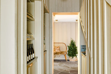 Small country gray floor, vaulted ceiling and wood wall hallway photo in San Francisco with green walls