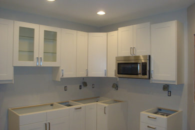 Example of a mid-sized trendy walk-out concrete floor basement design in Atlanta with white walls