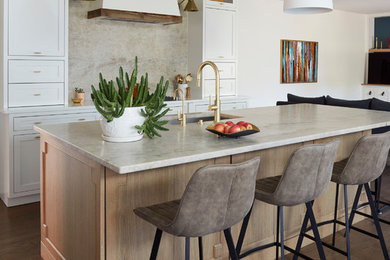 Inspiration for a transitional galley dark wood floor and brown floor open concept kitchen remodel in Chicago with an undermount sink, shaker cabinets, white cabinets, beige backsplash, stone slab backsplash, an island and white countertops