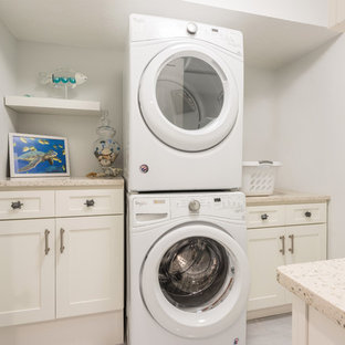 Inspiration for a medium sized classic galley separated utility room in Orlando with shaker cabinets, white cabinets, recycled glass countertops, grey walls, porcelain flooring, a stacked washer and dryer, grey floors and multicoloured worktops.