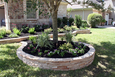 Photo of a large traditional full sun front yard concrete paver driveway in Houston for summer.