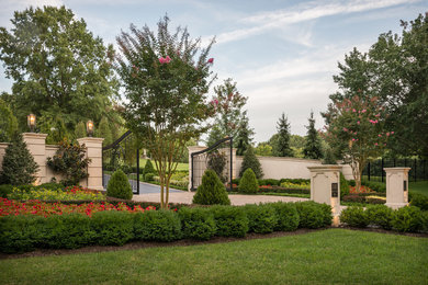 Photo of a huge traditional full sun side yard concrete paver driveway in DC Metro for summer.