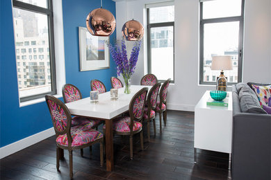 Mid-sized minimalist dark wood floor and brown floor great room photo in New York with blue walls and no fireplace