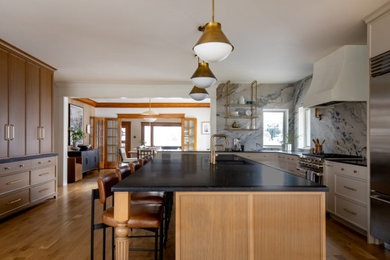 Example of a large classic l-shaped light wood floor open concept kitchen design in Salt Lake City with stainless steel appliances and an island