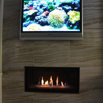 Tv panel above horizontal fireplace, tile background