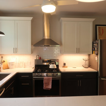 KITCHEN FEATURES SUBWAY TILE BACKSPLASH AND STAINLESS STEEL CENTER HOOD