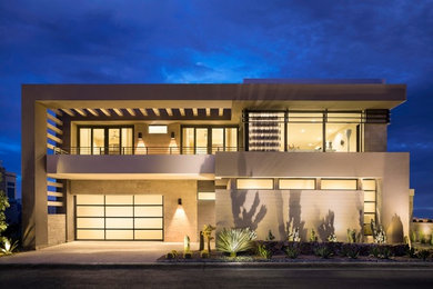 Example of a large trendy attached two-car garage design in Other