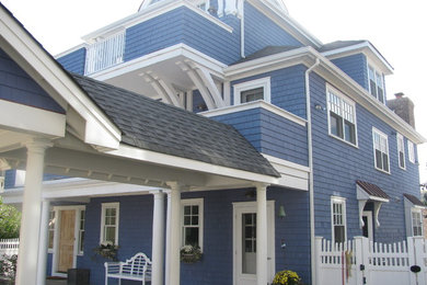 Mid-sized traditional blue three-story wood exterior home idea in New York with a hip roof