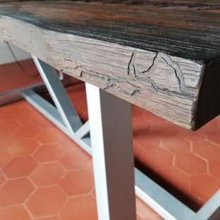 Design ideas for a modern study in Paris with grey walls, terracotta flooring, no fireplace, a freestanding desk and orange floors.