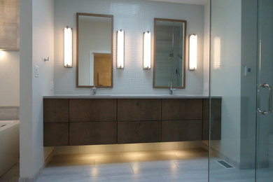 Bathroom - mid-sized contemporary master gray tile and glass tile ceramic tile bathroom idea in Other with flat-panel cabinets, brown cabinets, a two-piece toilet, gray walls, an undermount sink and quartz countertops