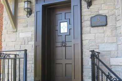 Photo of a mid-sized traditional front door in Toronto with a single front door and a brown front door.