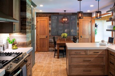 Example of a mountain style u-shaped porcelain tile and beige floor eat-in kitchen design in Phoenix with beige cabinets, quartzite countertops, gray backsplash, cement tile backsplash, stainless steel appliances and beige countertops