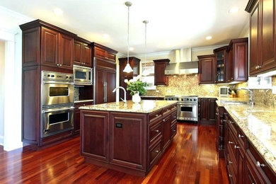 This is an example of a large contemporary l-shaped kitchen pantry in Baltimore with a drop-in sink, flat-panel cabinets, dark wood cabinets, granite benchtops, multi-coloured splashback, marble splashback, stainless steel appliances, dark hardwood floors, with island, brown floor and multi-coloured benchtop.