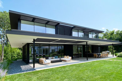 Inspiration for a mid-sized modern black wood house exterior remodel in New York