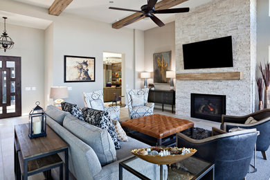 Large trendy formal and open concept porcelain tile and beige floor living room photo in Phoenix with gray walls, a standard fireplace, a stone fireplace and a wall-mounted tv
