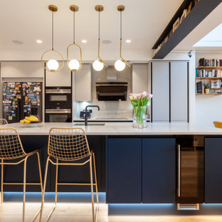 Inspiration for a contemporary kitchen in London with a built-in sink, flat-panel cabinets, grey cabinets, marble worktops, marble splashback, light hardwood flooring, an island and white worktops.