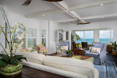 Example of a mid-sized beach style enclosed vinyl floor, brown floor and exposed beam family room design in Other with a media wall