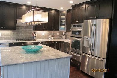 Inspiration for a mid-sized transitional u-shaped dark wood floor kitchen remodel in Denver with an undermount sink, shaker cabinets, dark wood cabinets, marble countertops, gray backsplash, subway tile backsplash, stainless steel appliances and an island