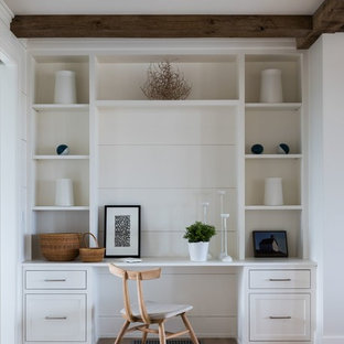 Inspiration for a medium sized coastal study in Providence with white walls, light hardwood flooring, no fireplace, a built-in desk and beige floors.